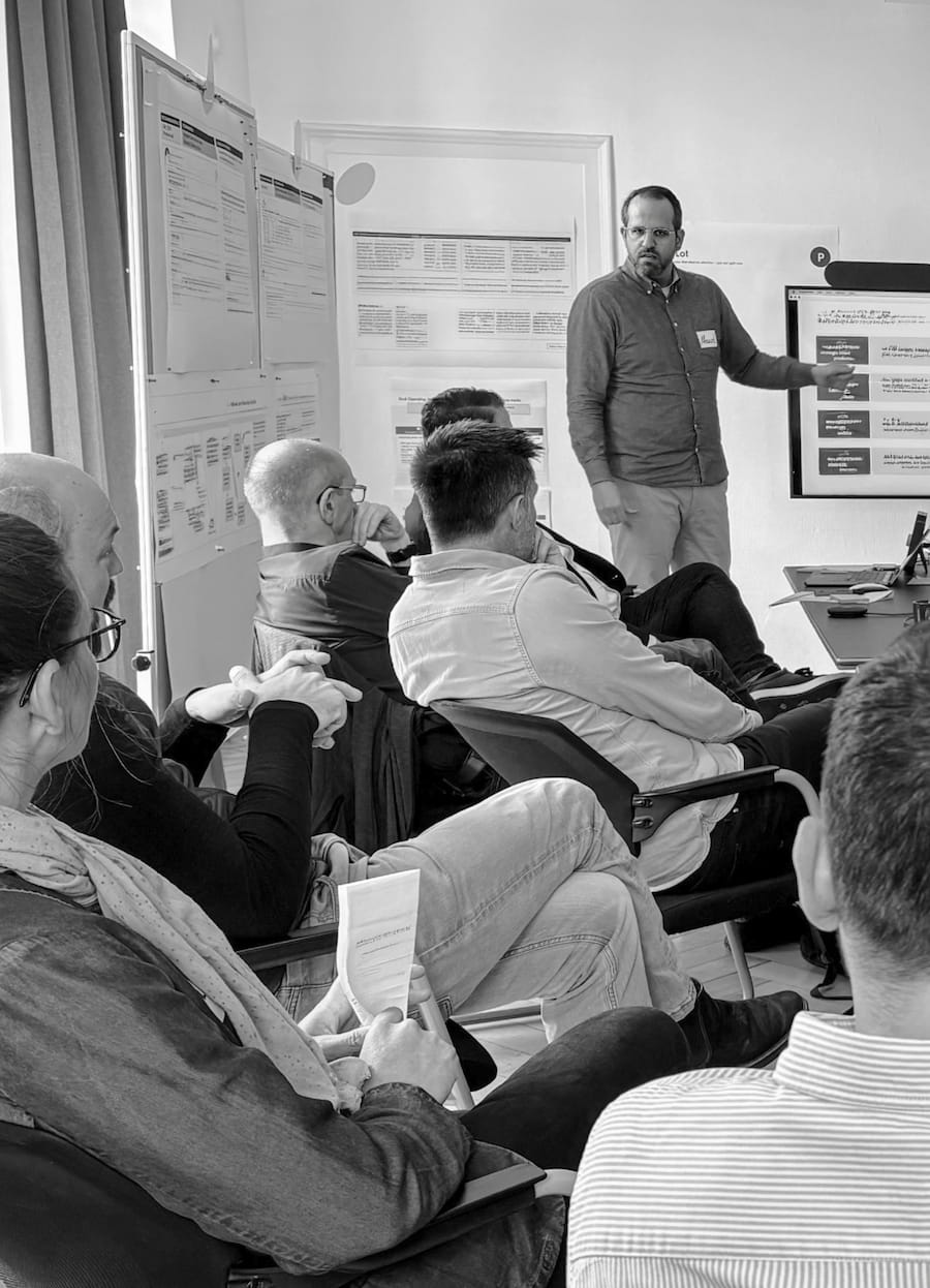 Manuel Hauff facilitating with wall-to-wall workshop posters